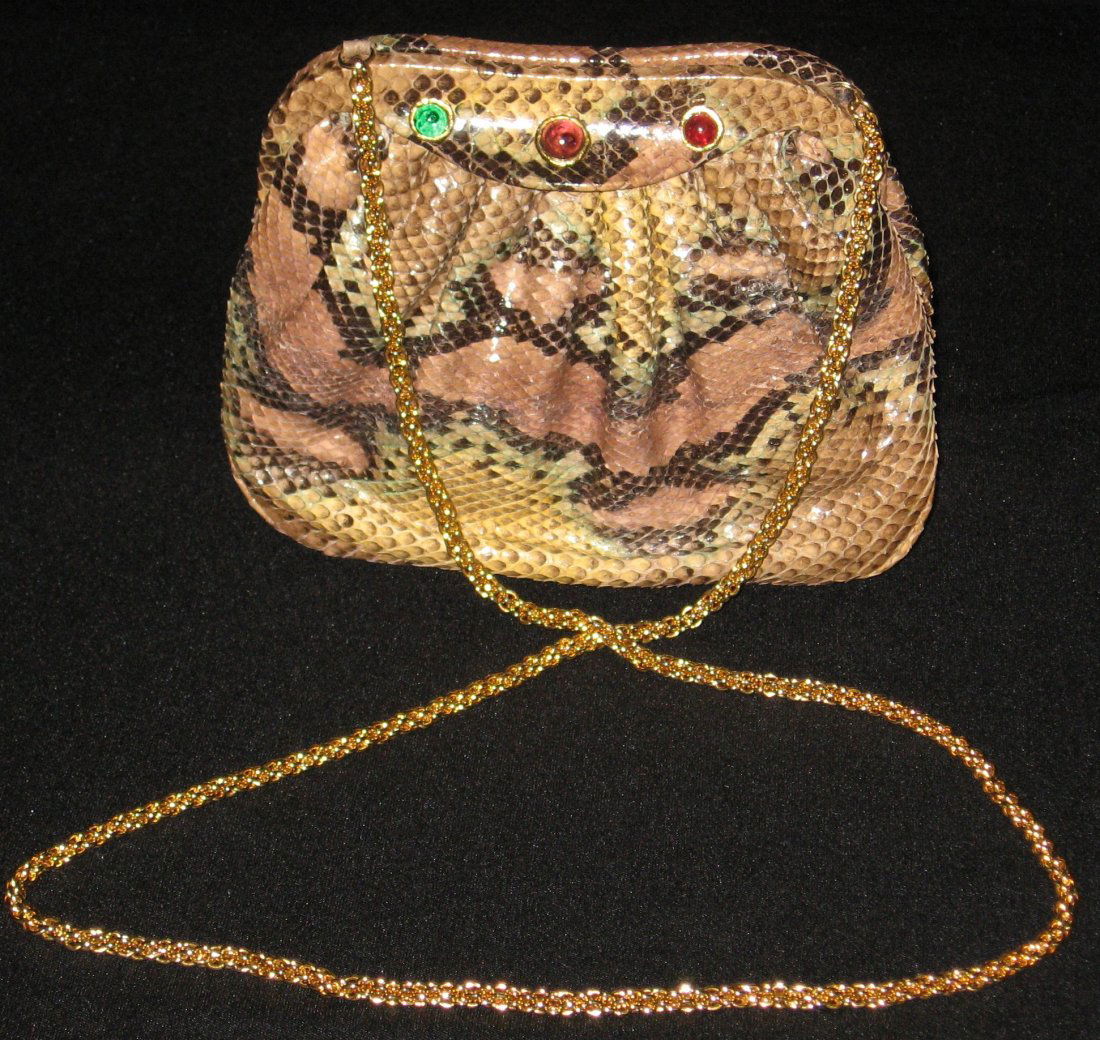 Chanel snake skin purse,: Snake skin purse in shades of red, green and tan accented with green and crimson jewels, gold tone chain handle and hardware, stitched CC on the bottom, marked Chanel Made in Italy, comes with a cloth