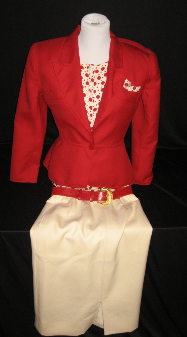 Oscar de la Renta wool suite,: including a red jacket with a polka dot blouse and cream skirt accented with a red belt, marked with factory label and Neiman Marcus store label, size 6-8.