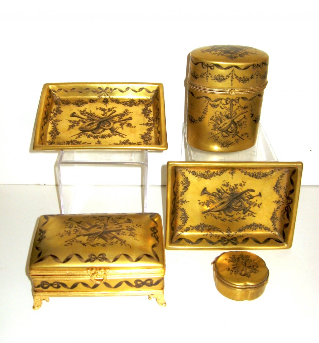 Le Tallec five piece dresser set,: each with overall iridescent gold and adorned with a musical instrument décor, including a large footed dresser box, a tall 4 1/2" ht. cylindrical box, a pill box and two trays, various Le Tallec mar