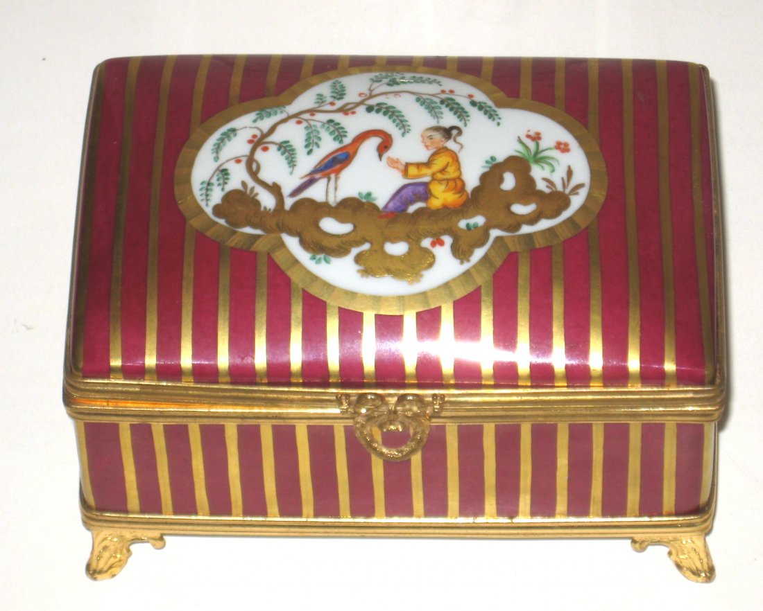 Large footed red Le Tallec box,: rectangular form with gold stripes and a central oriental pictorial medallion of egret and lady, marked Le Tallec a Paris, LT date and artist mark, 5 1/2" long.