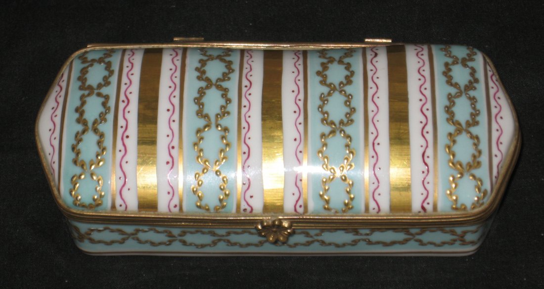Le Tallec decorated porcelain box,: elongated form with alternating bands of green and gold accent with crimson ribbon and gilt laurels, marked Le Tallec a Paris France LT date and artist mark, 4 1/2" long.