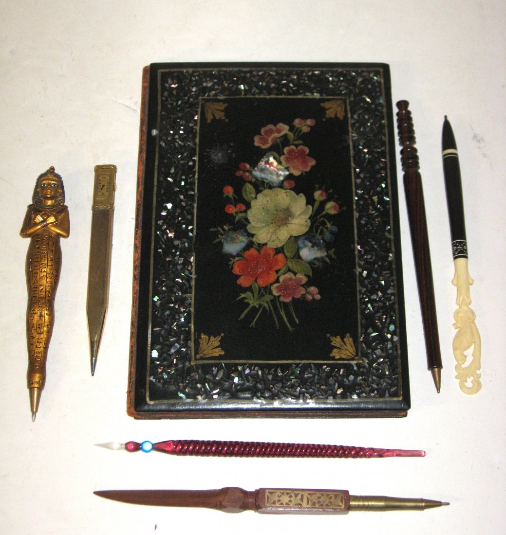Paper Mache tablet and six pens,: rectangular form black writing tablet decorated with a colorful flower décor, brown cloth interior with insert paper holder, together with six decorative pens, 9" ht.