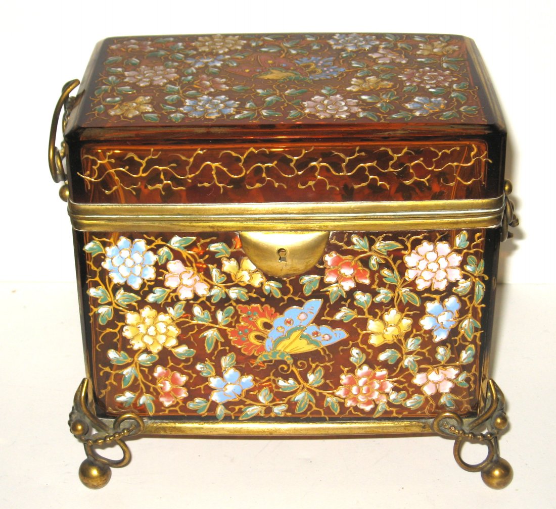 Large Moser decorated glass dresser box,: Amber dresser box with ornate ball and chain metal feet and handles, decorated with overall pink, blue, yellow, red and purple flowers and insects on green leafy scrolling, 7 1/4" wide.