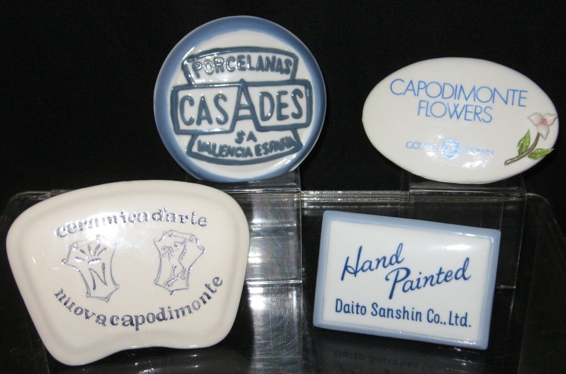 Four porcelain retailer signs,: including two Capodimonte, a Casades, and a Daito Sanshin, longest 6" long.