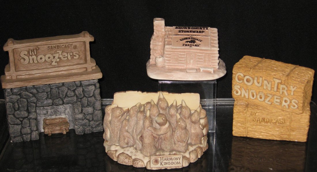 Snoozers, Harmony Kingdom retailer signs,: Four resin retailer signs including Country Snoozers, Lil Snoozers, Brown Country Stoneware, and Harmony Kingdom "Holding Court" with figural penguins and a cute wanted poster on reverse, tallest 5 3/