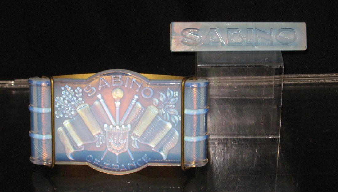 Two Sabino opalescent glass signs,: one triangular the other an ink blotter with emblem of flags, originally given to retailers, largest 6" long.