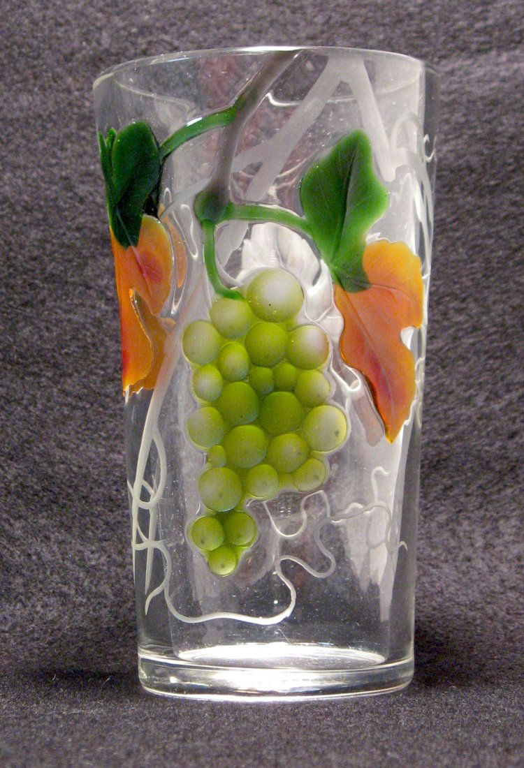Harrach intaglio cut tumbler,: clear crystal tumbler cut with a cluster of green grapes on dark green vines with cut amber leaves, although Moser and Harrach both did this work we believe this to be a Harrach tumbler, 5" ht.