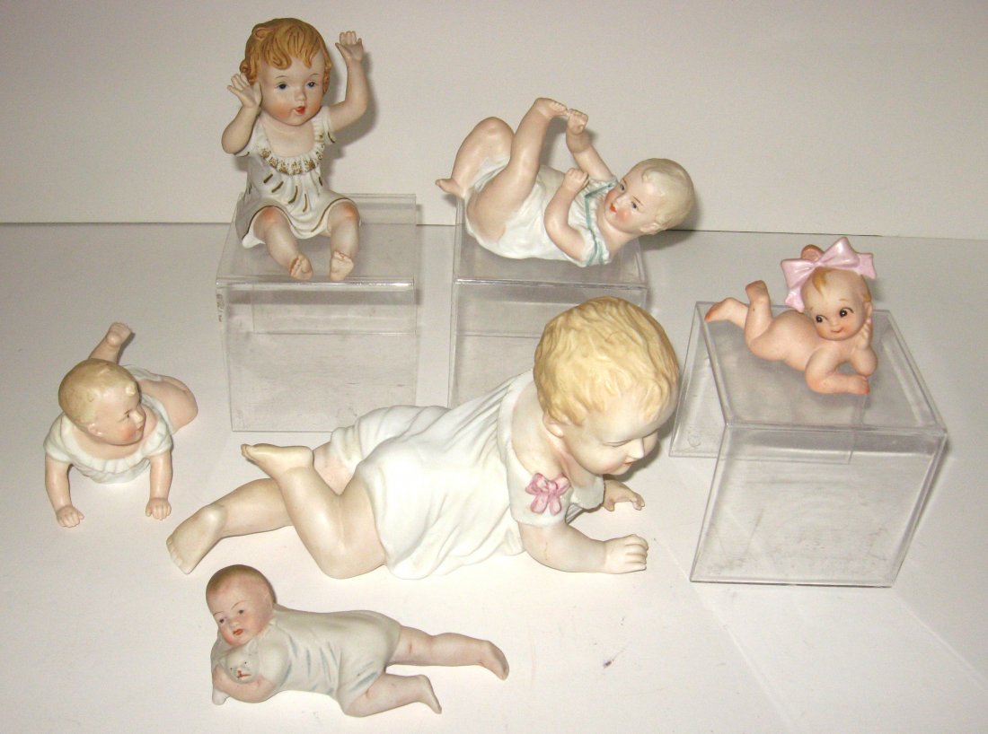 Group of porcelain piano babies,: Various sizes and makers including Heubach, largest 9 1/2" long.