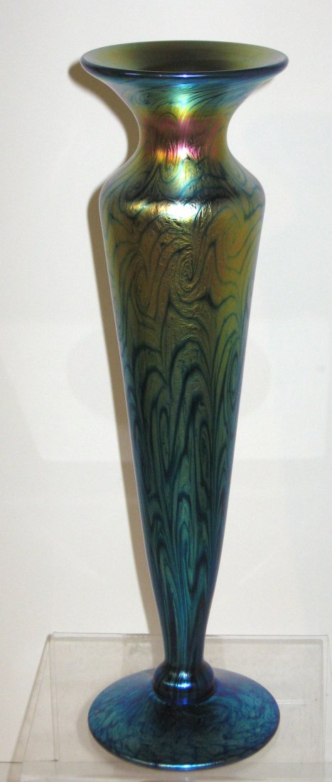 Lundberg Van Gogh Sunset glass vase: Footed bud vase in an iridescent blue glass graduating to a subtle gold decorated with a coil design, has original certificate signed Lundberg Studios 2004, 13" ht.