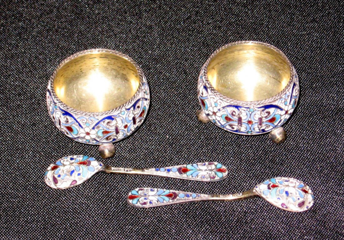 Pair of Russian silver salts and spoons,: Each salt with three feet decorated with scrolling enamel together with two spoons decorated front and back marked GK 84 AA, salts marked the same possibly for Gustav Klingert, 1 1/2" wide.