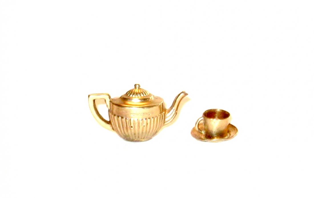9K gold tea pot and tea cup charm,: handled tea pot and tea cup charm both marked 375 and tested, tea pot 3/4" long.