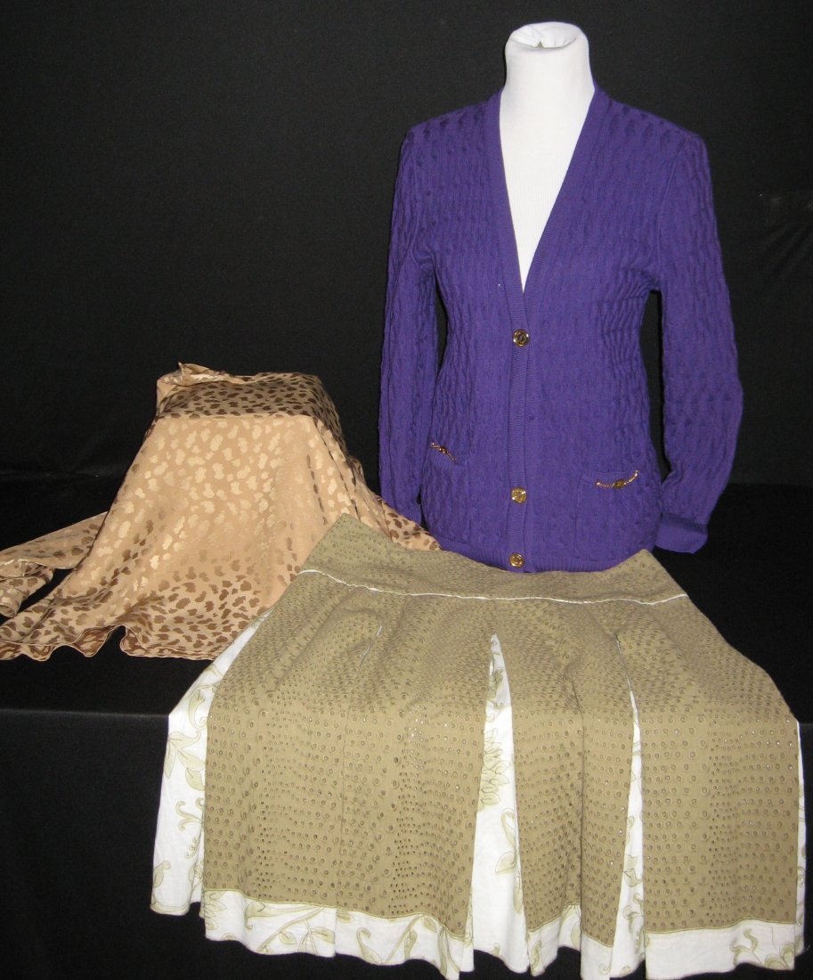 Three piece grouping of designer cloths,: Including a Celine tan Silk blouse approx size 40, a Celine purple sweater with gold tone buttons marked 38, and a size 12 Emanuel Ungaro skirt.