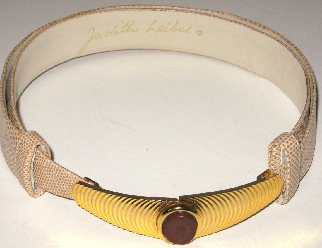 Judith Leiber leather belt: Tan snake skin adjustable belt with a gold tone buckle with central red cameo medallion of a Roman Centurion, signed Judith Leiber, fits 22' to 35" waist.