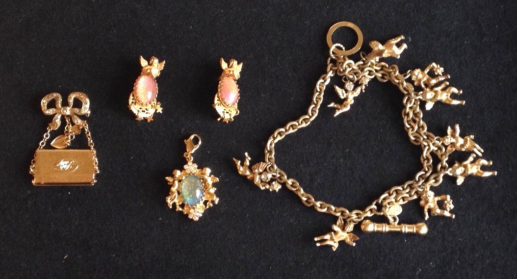 Group of Kirks Folley costume jewelry,: Including an angel bracelet, a pair of earrings with red aventurine stone, a dropped pendent with blue aventurine stone, and a bow and letter shaped brooch, all marked.