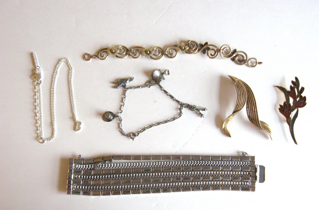 Group of designer costume jewelry,: Including a Hobe seven band bracelet, signed Hobe, together with signed Kenneth Cole necklace with the letter B, a Trifari gold tone pin, a marked Krementz gold tone bracelet with flowers, and an enam