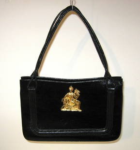 Martin Van Schaak handbag,: Black handbag with a gold tone medallion of female Romanesque warrior and horse, marked in gold on the interior Martin Van Schaak, without handle 12 1/2" long by 8 1/2" ht.