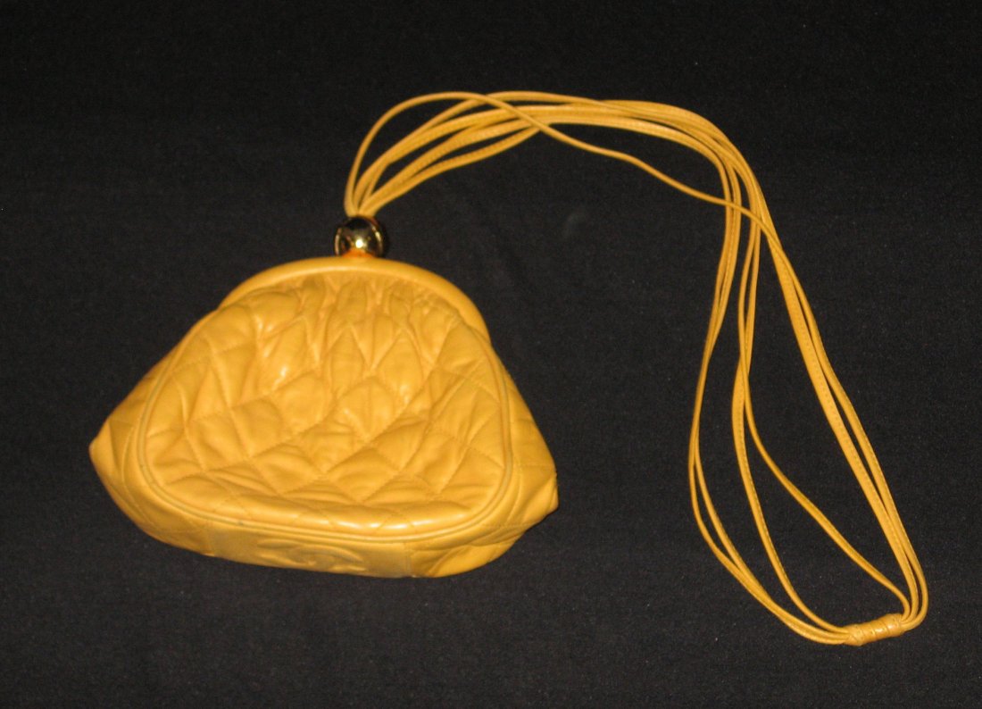 Vintage Chanel leather bag,: Small quilted yellow bag with gold tone ball clasp, stitched double CC on the bottom, marked in interior Chanel Made in Italy, with hologram, without draw string handle 7" wide by 6" ht.