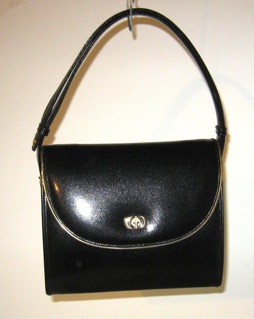 Gucci black leather purse: Triple sectional black leather purse with gold trim and gold tone hardware with adjustable strap to make it a hand bag or shoulder, marked Gucci on interior and zipper, comes with tan dust bag. Withou