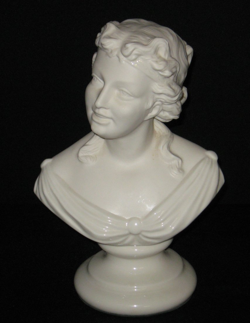 Belleek "Bust of Joy" figurine,: bust of a young happy women on a pedestal base, green felt bottom marked on back Belleek Ireland, 11" ht. LITERATURE: see "Belleek The Complete Collector's Guide" by Degenhardt page 121.