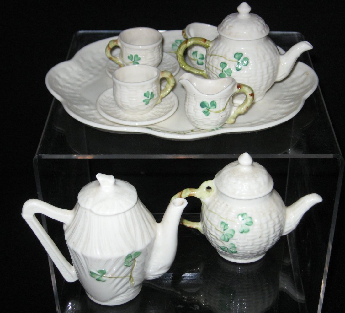 Group of Belleek miniatures,: Including a "Harp" form tea pot 3" ht., together with a shamrock tea kettle 2 3.4" ht. and a Childs tea set, all marked Belleek, tea set tray 7" long