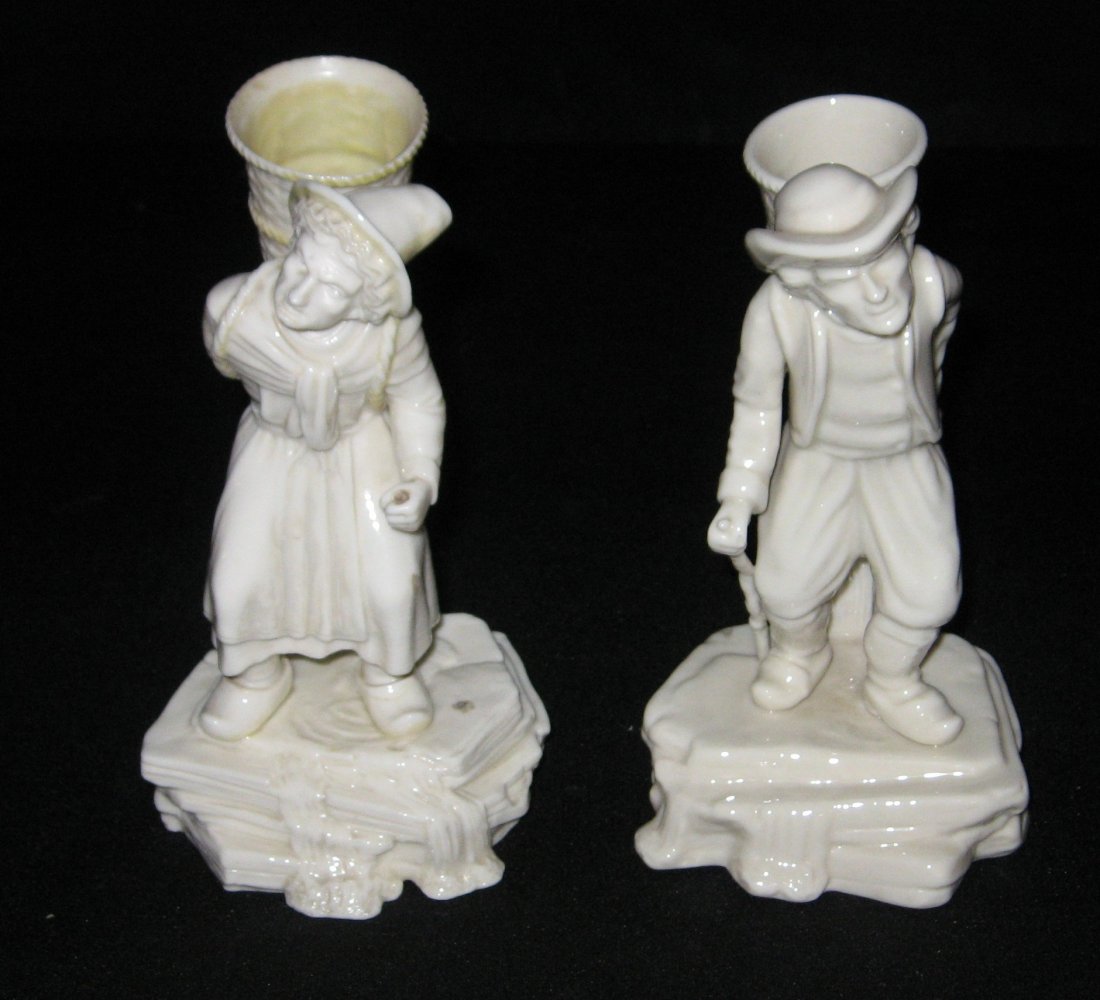 Pair Belleek "Belgian Hawker" figurine,: footed statue of a Continental man with a basket and cane, 6th mark, together with the matching women figurine, 1st black mark, 7" ht.