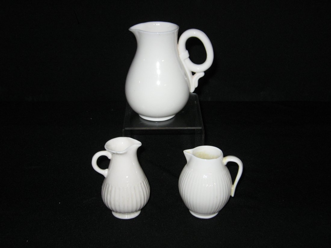 Three rare Belleek earthenware pitchers,: Including two with vertical ribs and a larger with ring handle, each with the 1st black mark, tallest 4 1/2" ht.