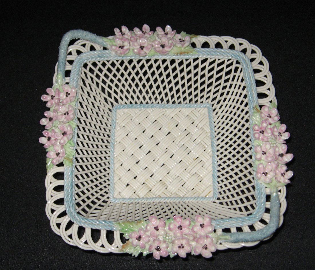 Belleek Fermanagh square basket,: Four stand basket with a blue handle rim adorned with clusters of pink flowers, marked Belleek R Co. Fermanagh, 8 1/4" wide.