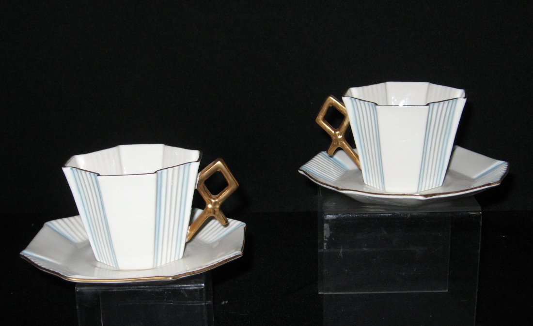 Pair of Belleek "Fan" pattern cups and saucers,: Art Deco with ridged panels with blue highlights, trimmed in gold, 11th mark, 5 1/4" wide.