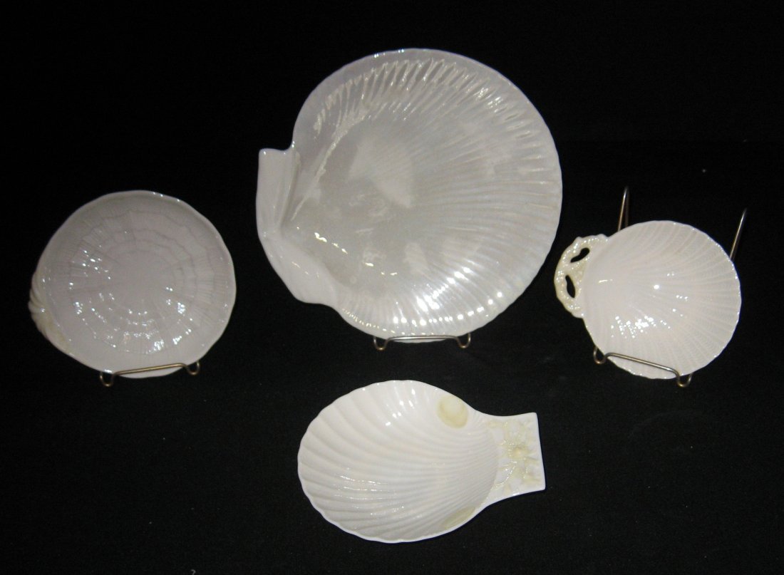 Four shell form caddy dishes,: Largest pearl finish shell dessert plate marked with an incised mark, the other three with 4th and 5th green marks, largest 8 1/2" wide.