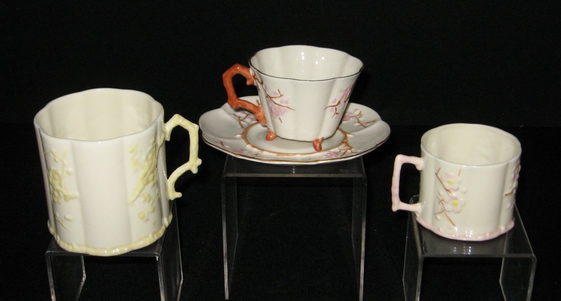 Four piece grouping of Belleek Thorn,: Including a cup and saucer with pink flower 11 mark, together with a pink flower mug and a yellow flower mug, 7th amber mark, tallest mug 3 1/4" ht.