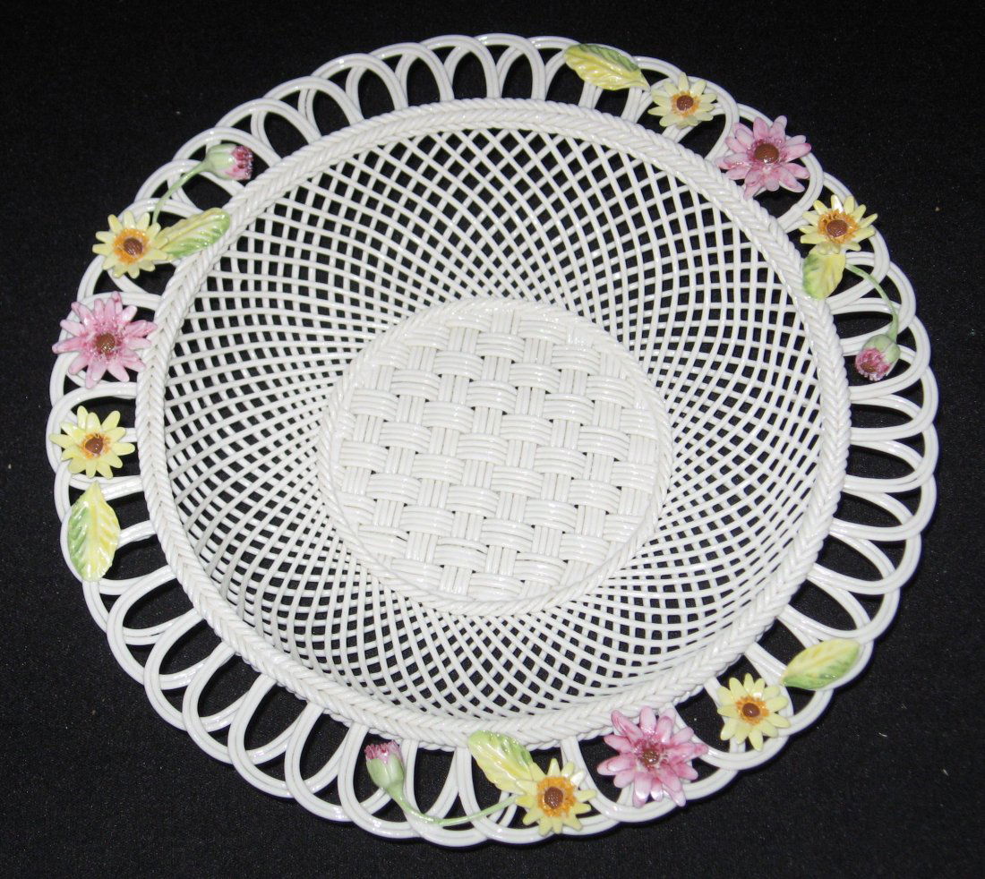 Belleek four stand basket,: Circular form basket with open scrolling rim with pink and yellow flower, annual 2006 mark, 9" ht.