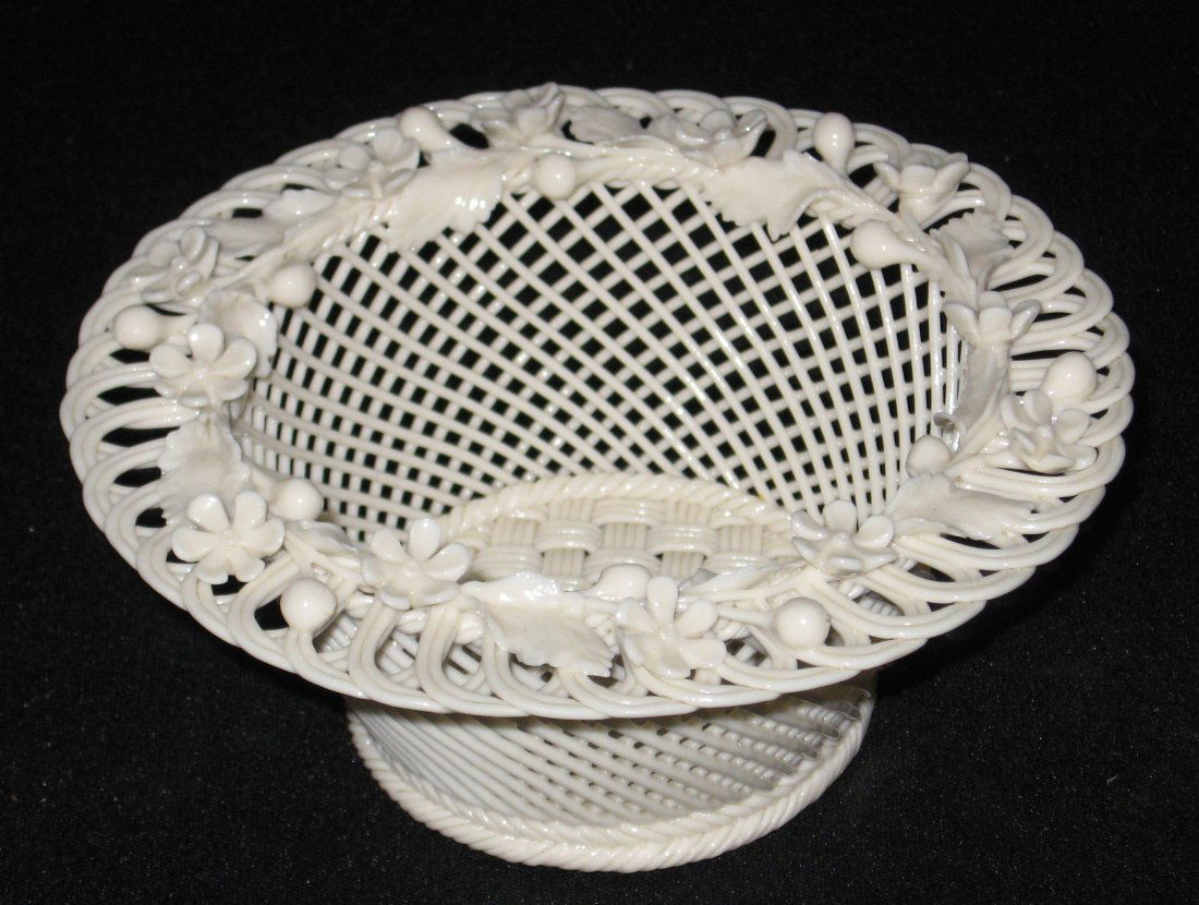 Belleek four stand basket,: Round basket decorated with a scrolling rim and flowering branch, marked with a banner Belleek R Ireland, 6" wide.