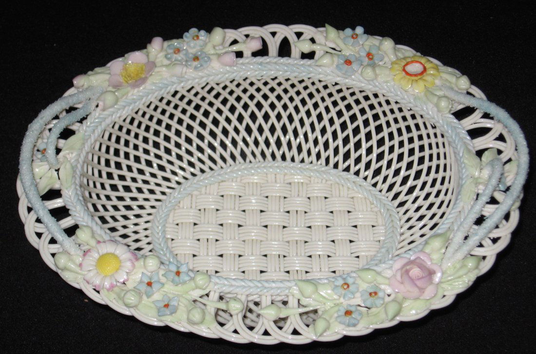 Irish Belleek blue handle basket,: Oblong four stand basket with clusters of spring flowers and blue scrolling, marked Belleek R Ireland, 9" long.