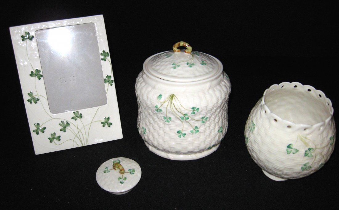 Group of Belleek Shamrock items,: Including a 5th mark Covered cookie jar, a picture frame, an amber marked votive candle lamp vase, and a lid, picture frame is not marked, cookie jar 7" ht.