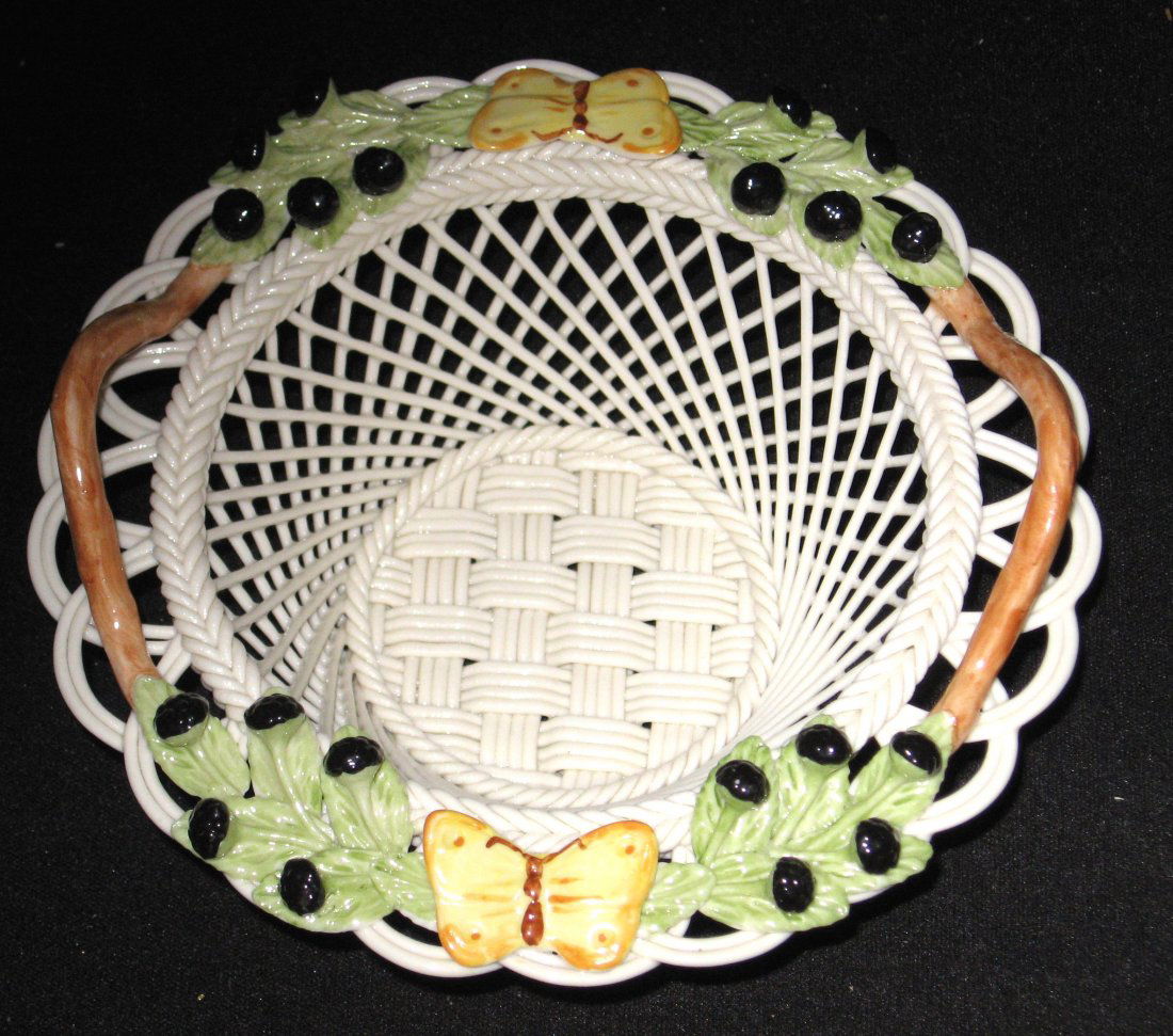 Belleek 4 strand brown handle basket,: Oval form decorated with berries and butterflies, 11th mark, 5 1/4" wide.