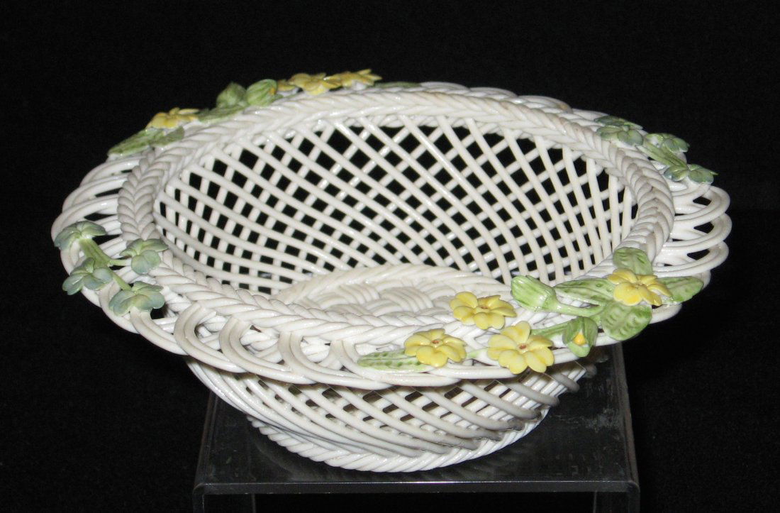 Belleek 4 strand "Spring" basket,: Round basket with an open rim decorated with yellow flowers, 8th mark 6 1/4" wide.