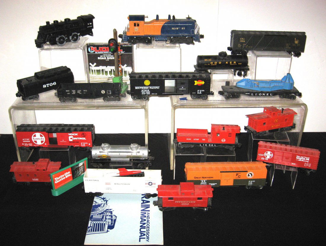 Mid 20th century Lionel train,: 17 car train with a 6250 Seaboard engine, Minuteman missile car, a T & SF engine and coal car, box cars, tankers and caboose together with crossing light, box of signs and Manuel.