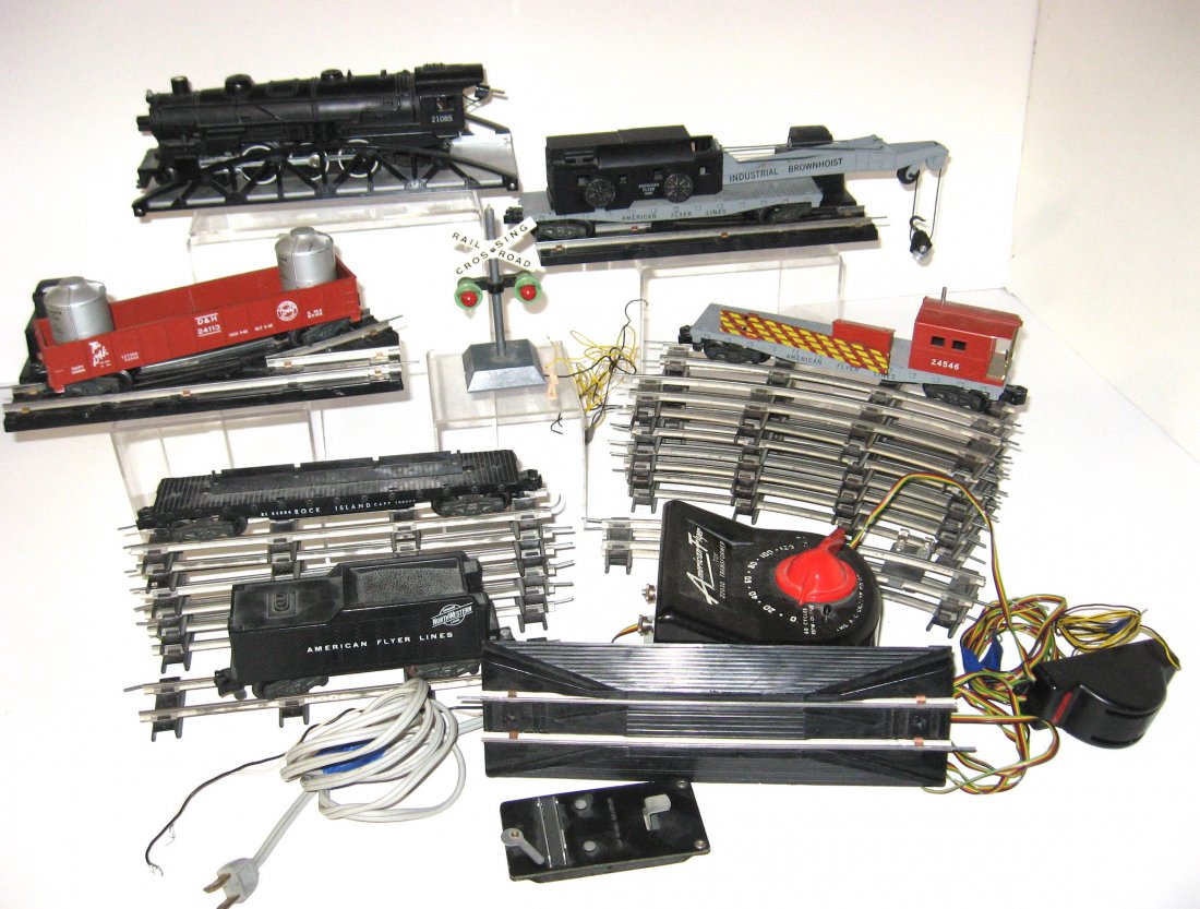 American Flyer 1950's train and track,: seven straights, 16 curves two with electric hook ups, 22030 transformer, crossing guard, engine, crane, bridge, and more. The train has been stored for 40 years in a metal New Era potato chip tin fro