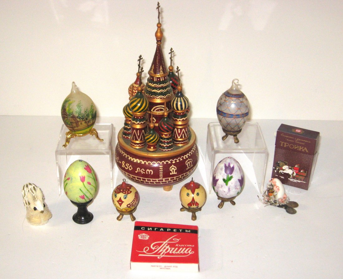 Group of Russian items,: Including a music box, hand painted glass and wood eggs, hand made squirrel and egg with bird in nest, and two empty cigarette boxes. 11" ht.