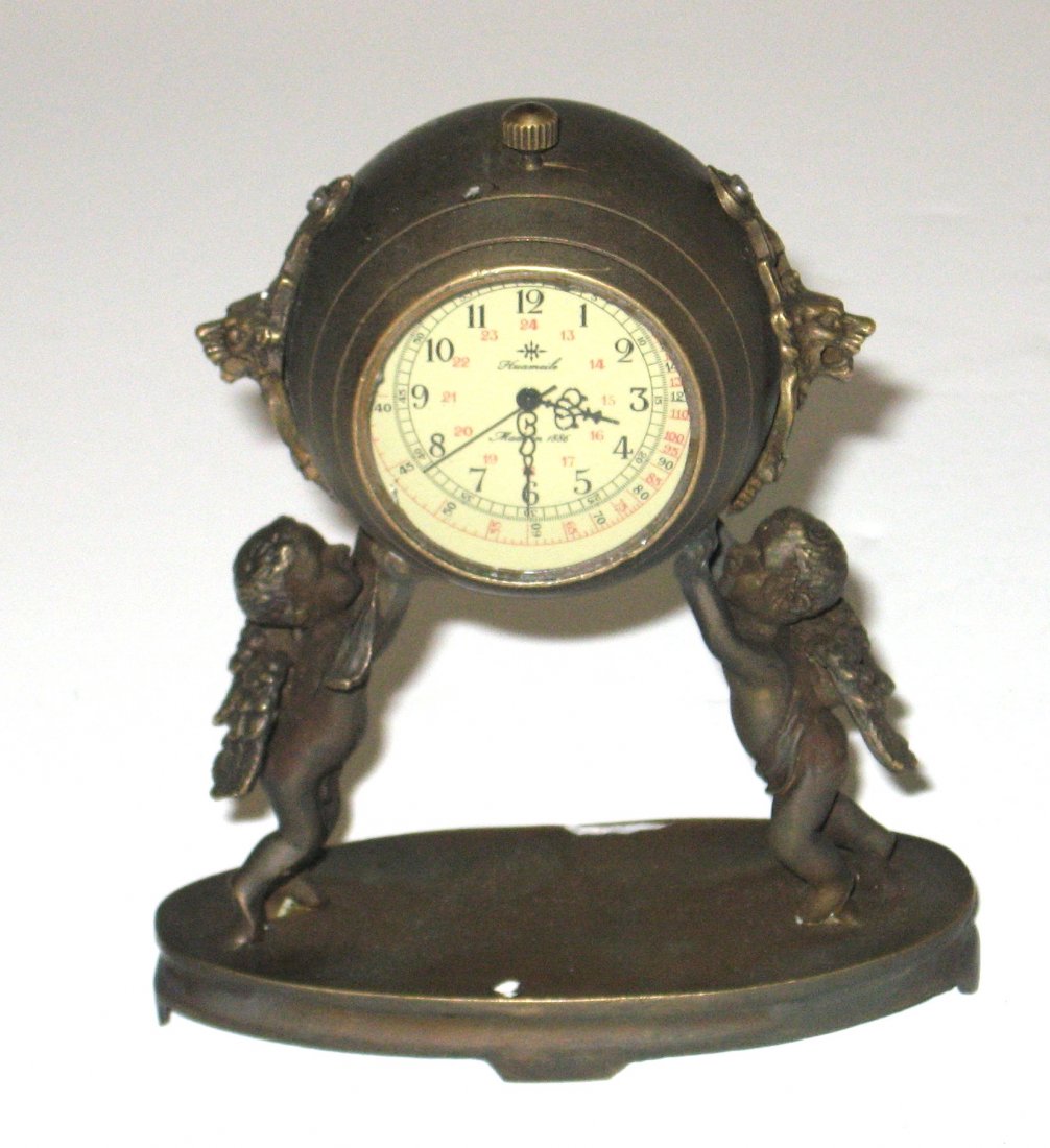 19th century bronze figural clock,: Diminutive figural clock with two cherubs holding up a clock globe, face marked Huameile 1886, Still in working order, 4 1/2" ht.
