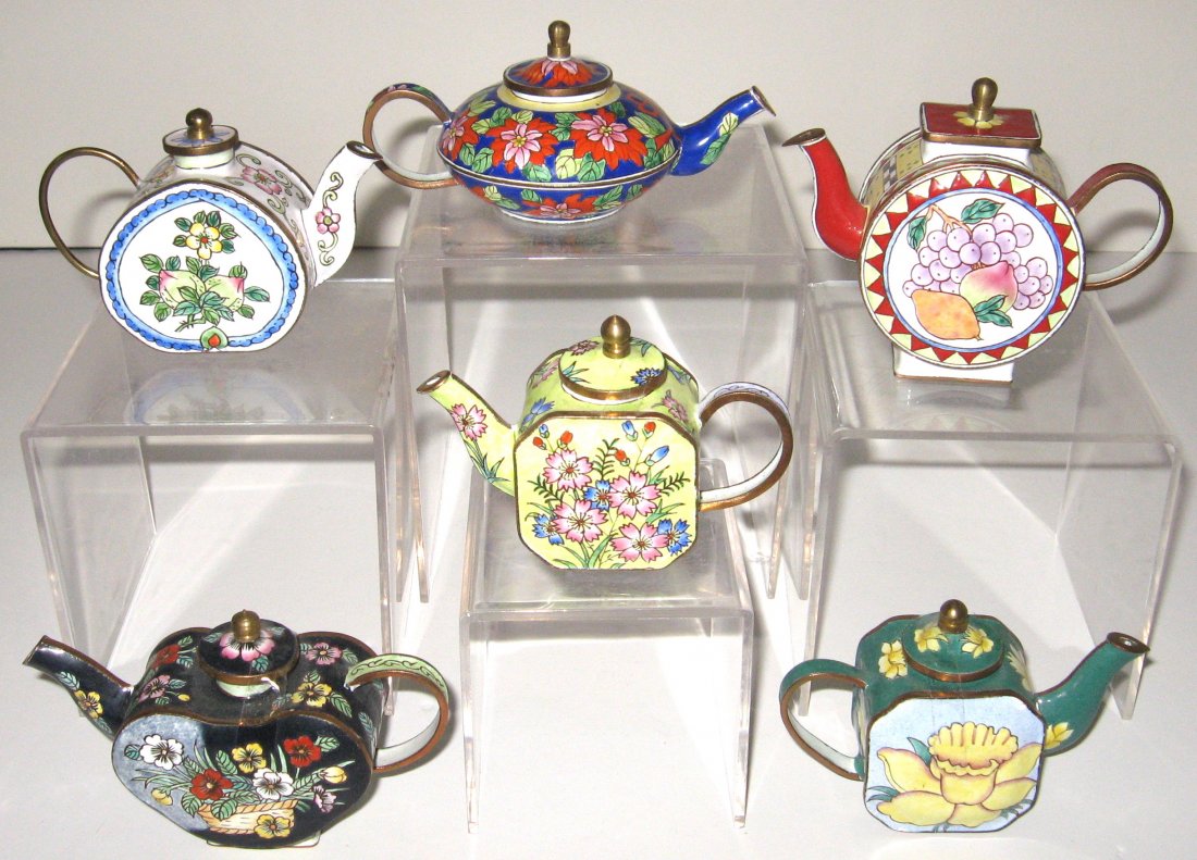 Six enameled metal diminutive tea pots,: Each decorated with flowers, one marked Kelvin Chen, tallest 3" ht.