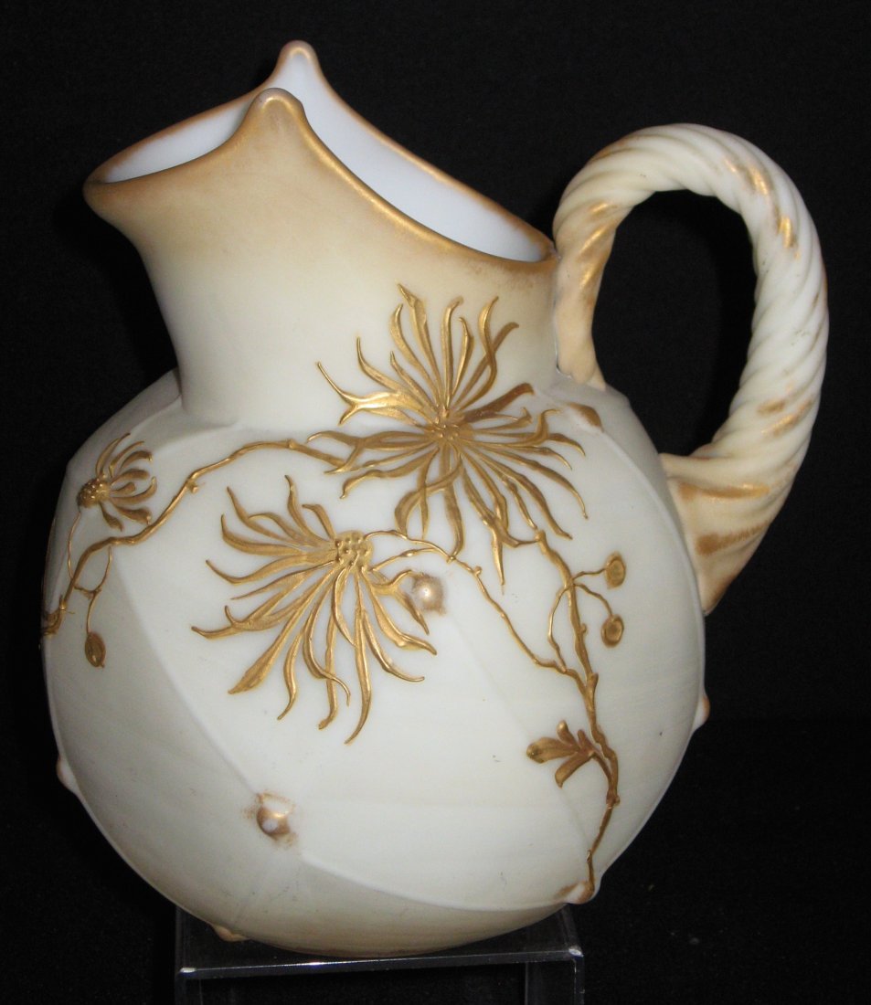 Mt. Washington Crown Milano water pitcher,: Ovoid form in opal glass decorated with stemmed gold mums and adorned with a rope twist handle, marked with the CM and crown factory mark, 8 1/2" ht.