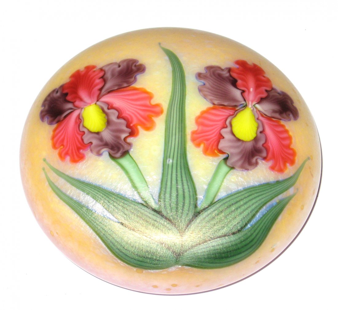 Orient and Flume paperweight: Iridescent yellow paperweight with red and purple stemmed iris, signed and carries a paper label, 4" ht.