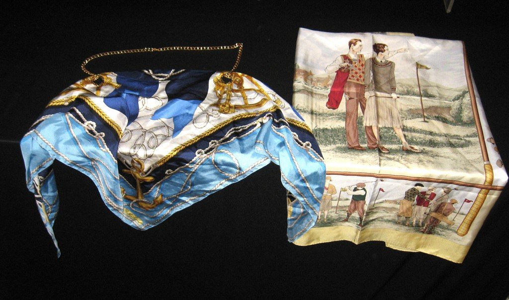 Two Ralph Lauren silk scarves.: Nice Ralph Lauren yellow scarf with golf scenes, marked Ralph Lauren on the driver, 34 by 34. Together with a blue Nautical scarf with gold tone chain marked on scarf and chain, 44" at the longest.