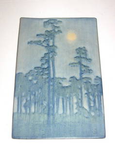 Rare Newcomb pottery plaque,: Rectangular plaque in blue pottery decorated with a moon peering through a blue forest, marked with an original paper label, 9 1/2" ht. by 6" wide.