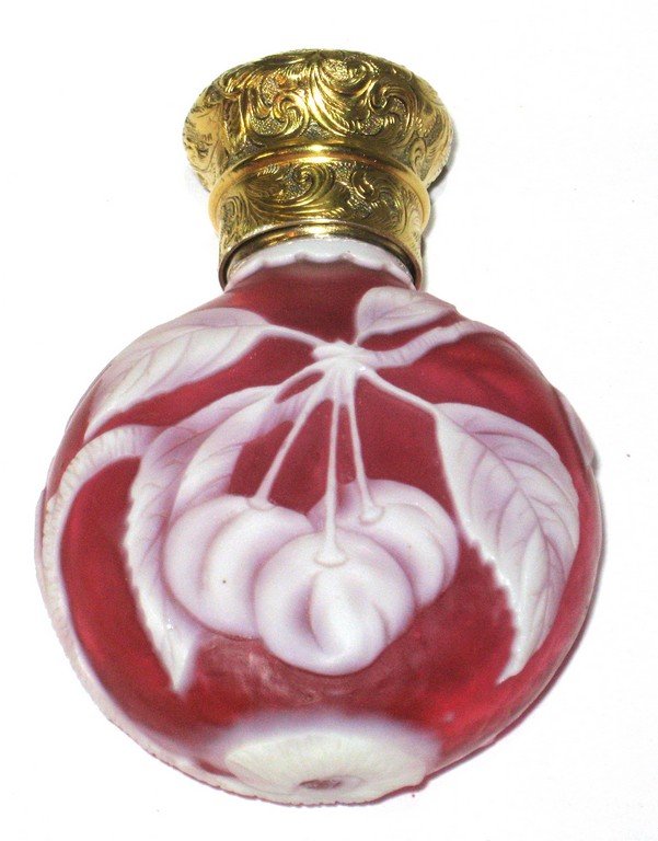 Rare Thomas Webb and sons cameo perfume,: Ovoid form in red glass decorated with three cherries on leafy branches, reverse with two cherries fitted with a gold plated scrolling cap, 3" ht.