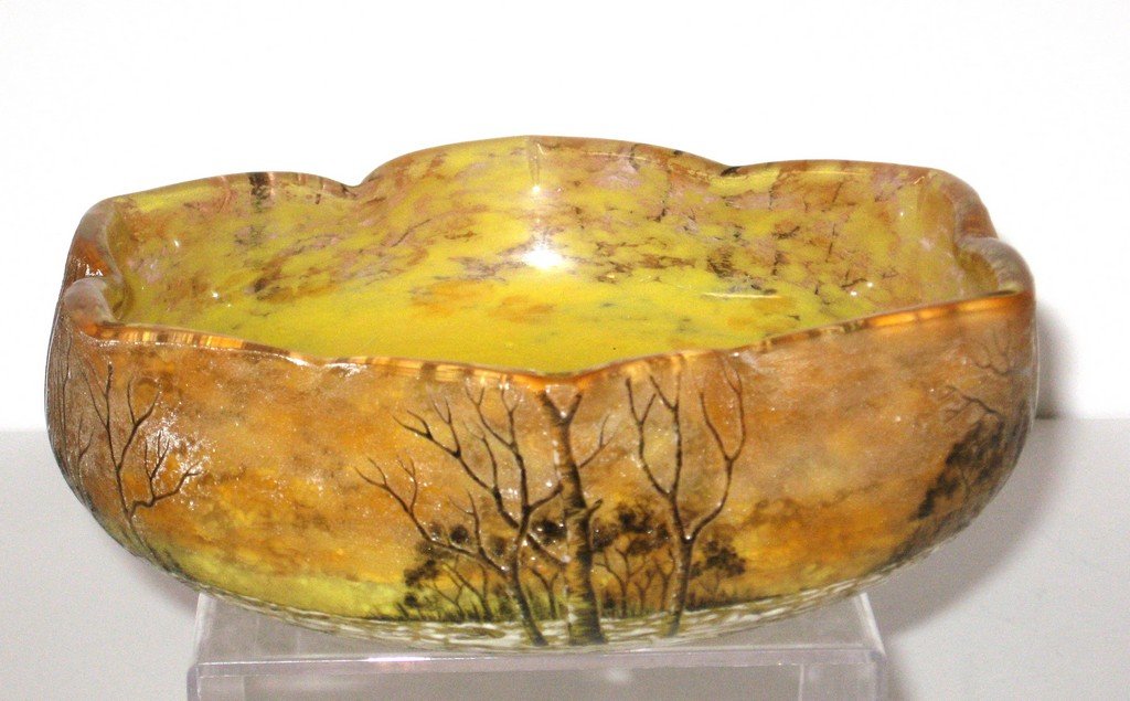 Daum Nancy French cameo winter scene,: Large ovoid form bowl with a six point star rim in orange and yellow mottled glass decorated around with a winter forest scene of snow covered meadow with brown trees, signed Daum Nancy, 8" wide.