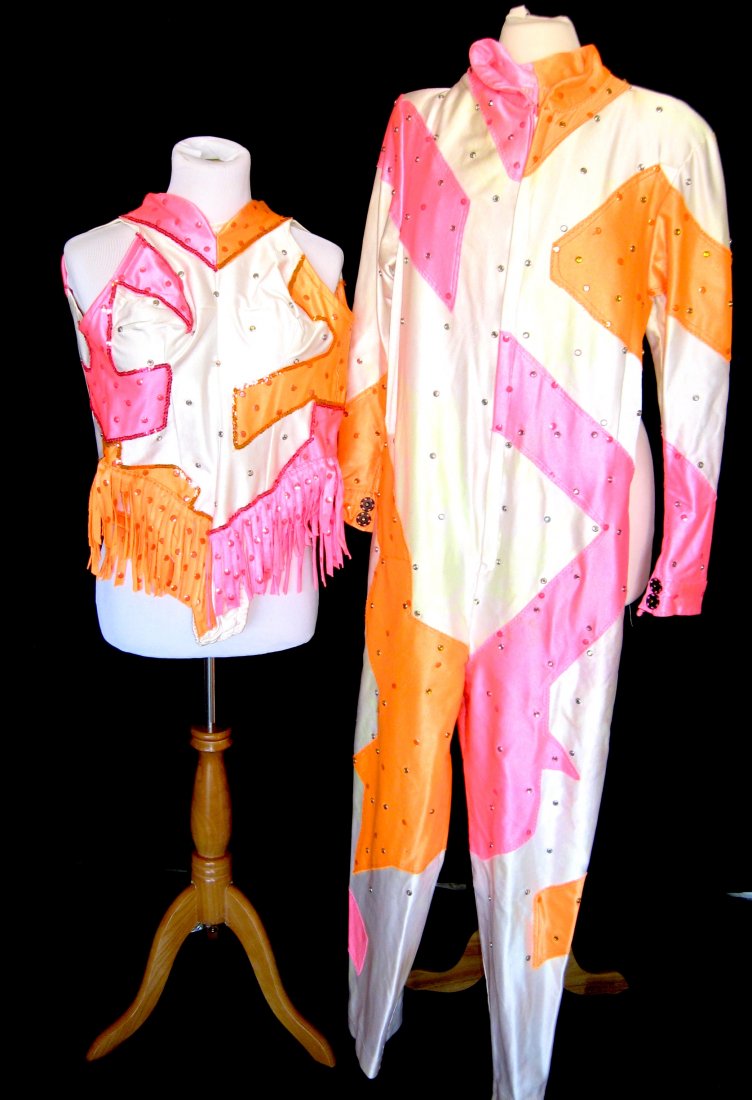 Two Urias Troupe circus costumes,: Consisting of a mans and one women's costume in white decorated with shades of orange and pink and accented with sequins, designed by Don Foots. PROVENANCE: Victor and Kathia Urias to current owner.