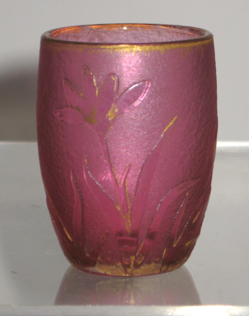 Daum Nancy French Cameo glass whiskey: Diminutive Whiskey in red glass decorated with gilt flowers, signed Daum Nancy, 2" ht. Condition: good, with no chips, cracks, or repairs.