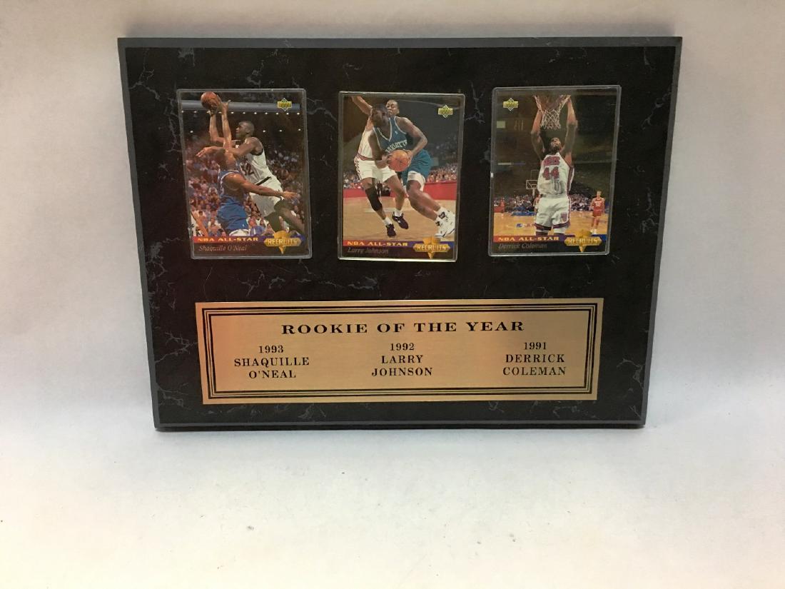 plaque of basketball cards: rookie of the year 1993 shaquile o'neal, 1992 larry johnson, 1991 derick coleman